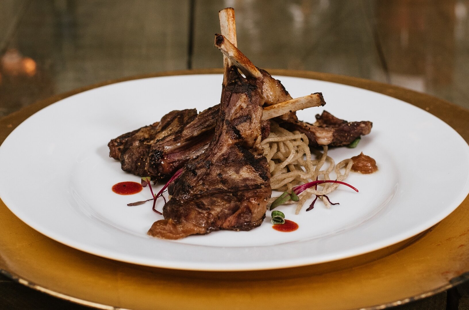 Lamb lollipops crusted in herbs over wild rice
