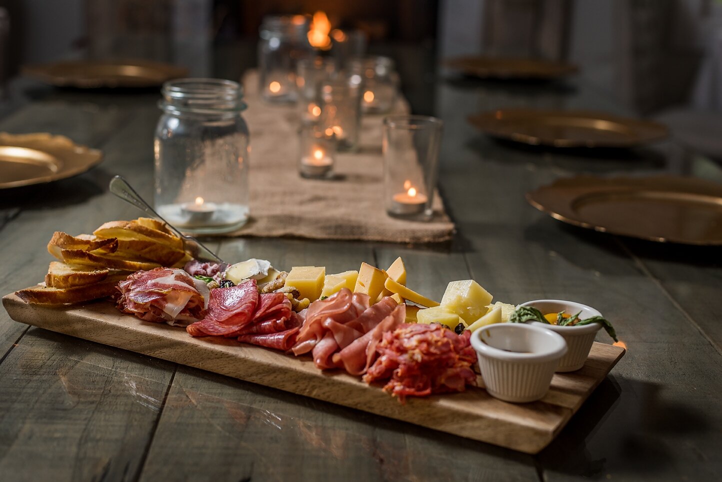 Charcuterie board with cured meats, cheeses, jams and bread