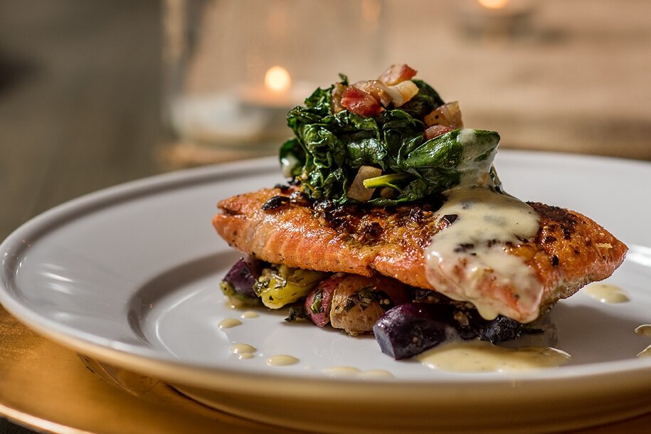 Pan-seared salmon with wilted greens and tri-color potatoes