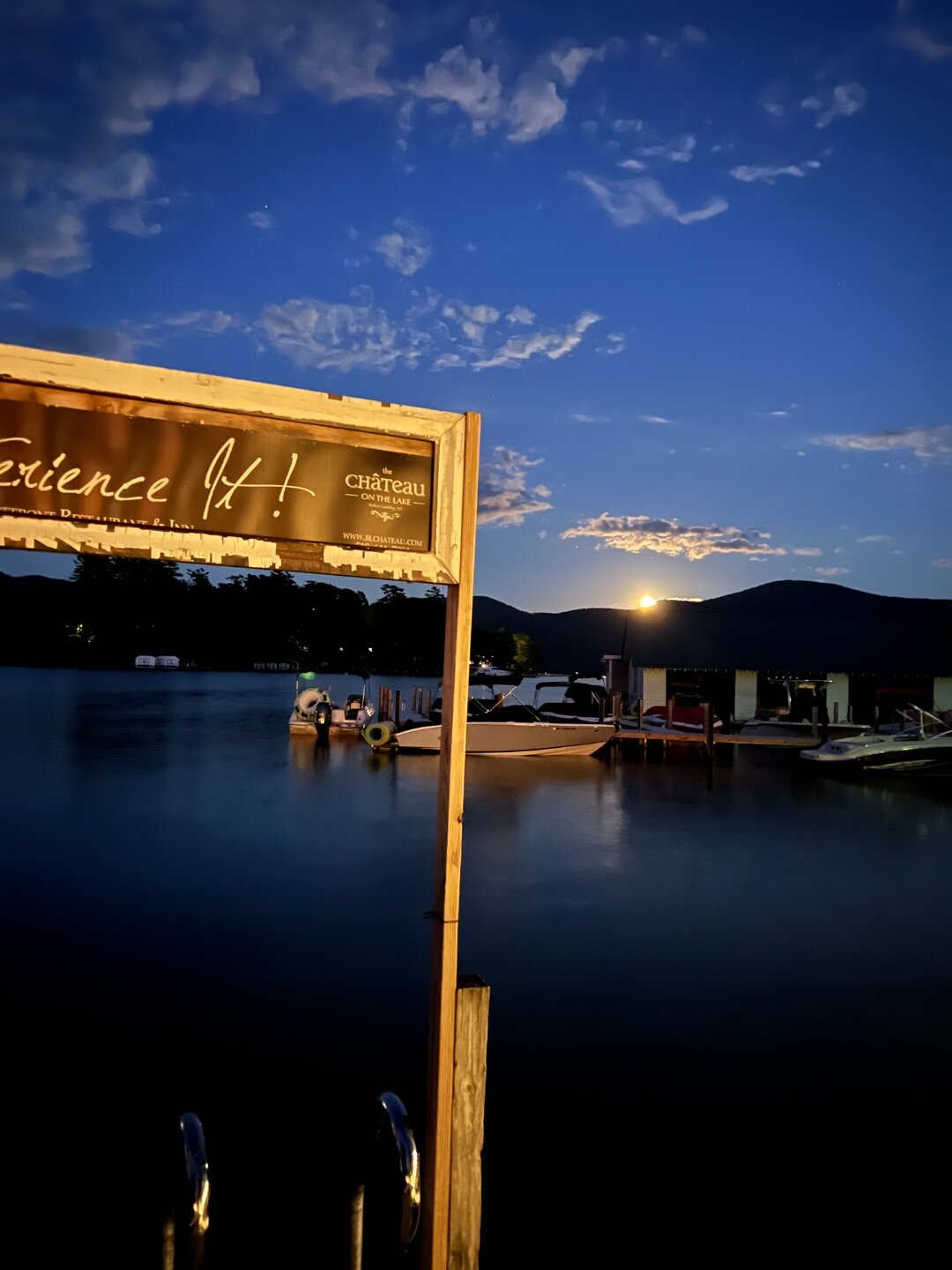 The Château On The Lake at night with the moon over Lake George